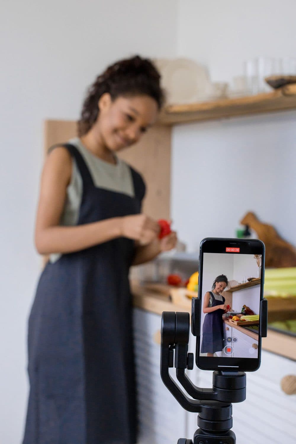 Example video: a creator cooking in her kitchen while a phone on a gimbal records her